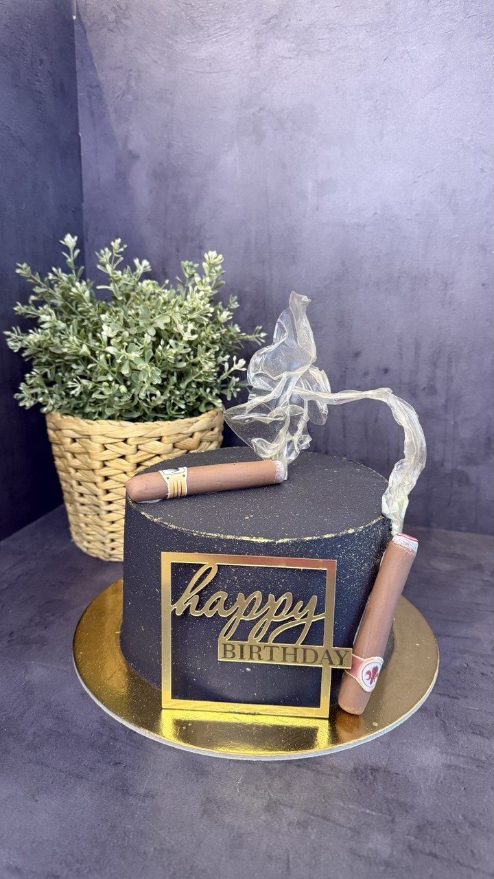 Black and gold birthday cake with cigars