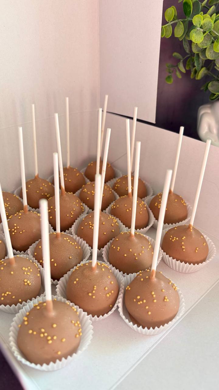 Milk chocolate cake pops with gold sprinkles