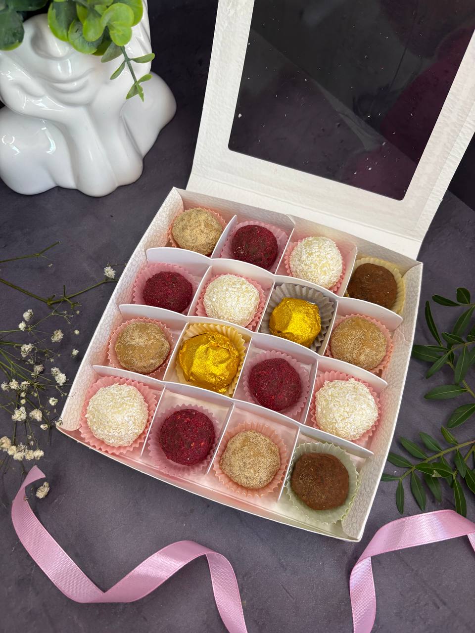 Assorted truffles and bite-size desserts in a gift box