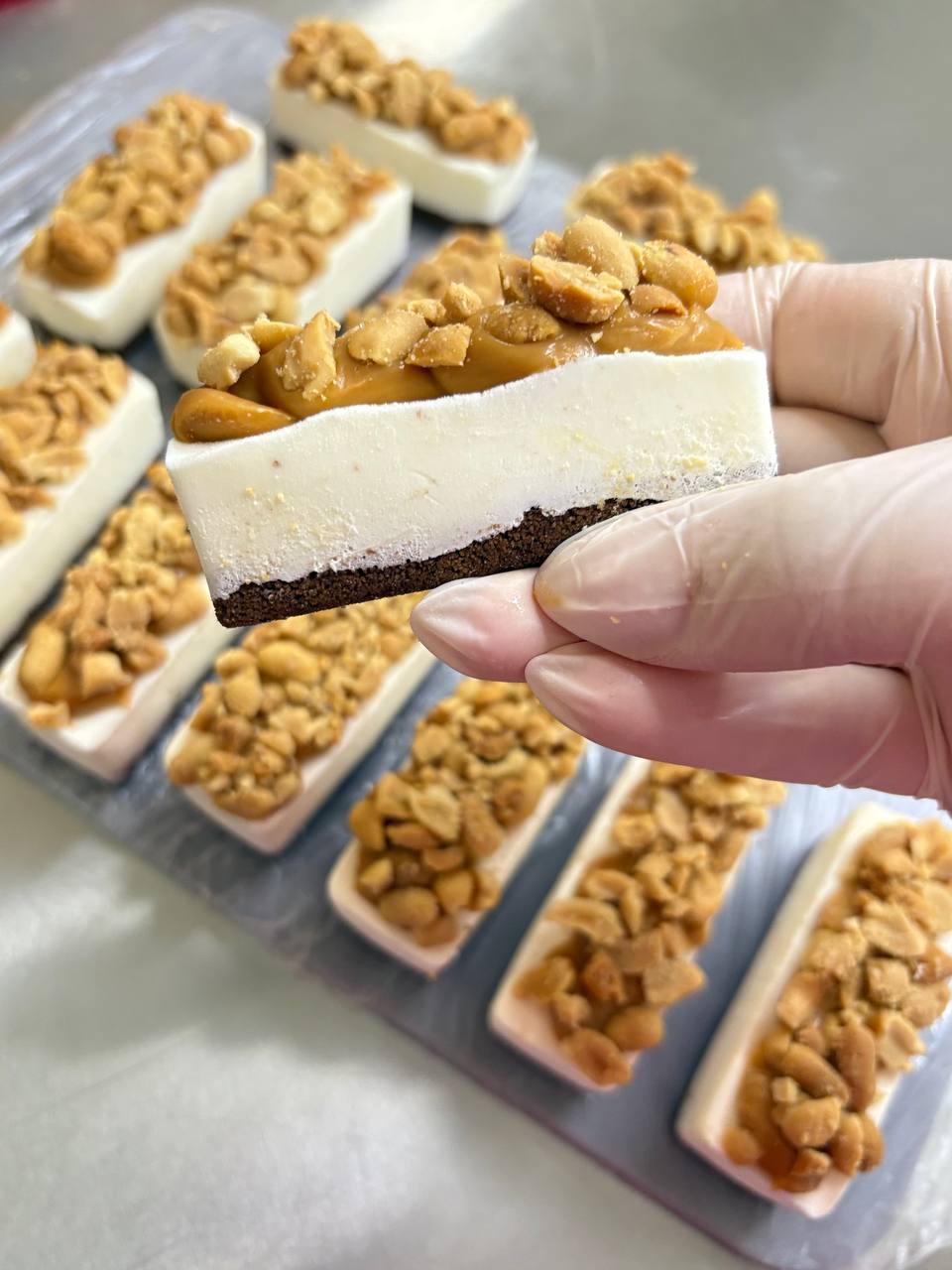 Snickers-style bars with peanuts and caramel on chocolate base