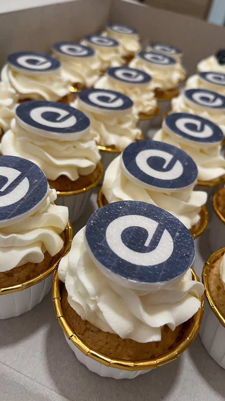 Corporate cupcakes with Expedia gold logo toppers