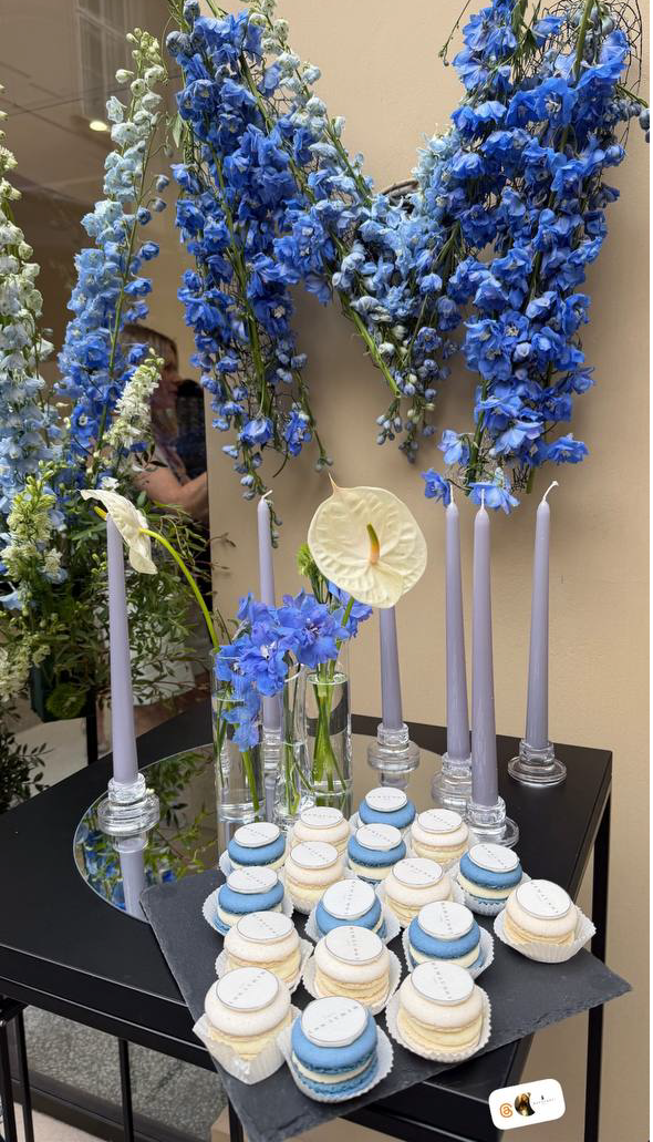 Branded macarons dessert table with blue delphinium