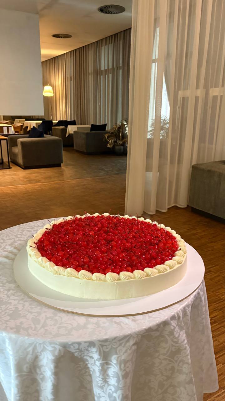 Large cherry-topped cheesecake for corporate event