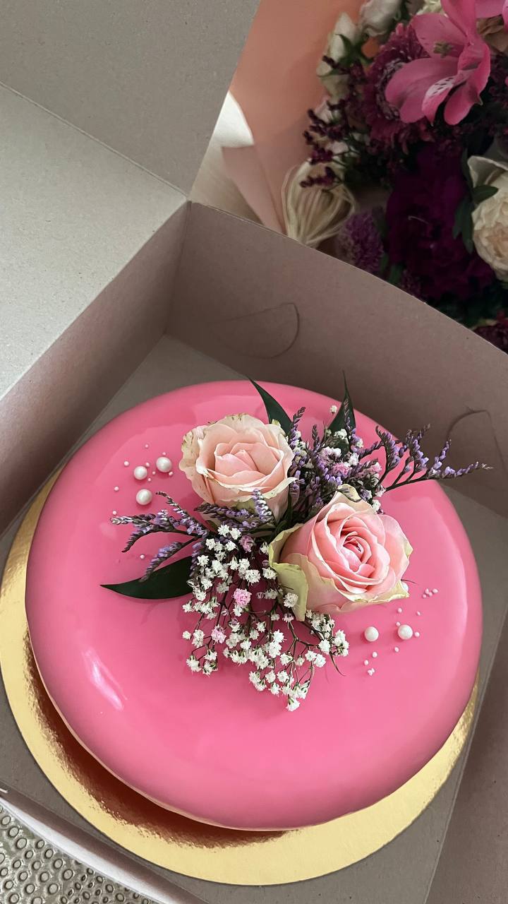 Pink mirror-glaze cake with fresh roses