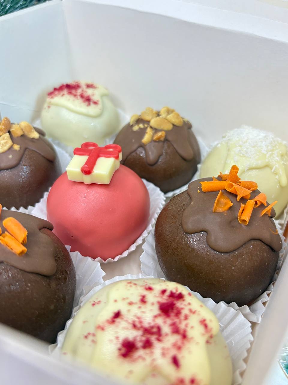 Assorted truffles with peanuts, coconut and berry sprinkles
