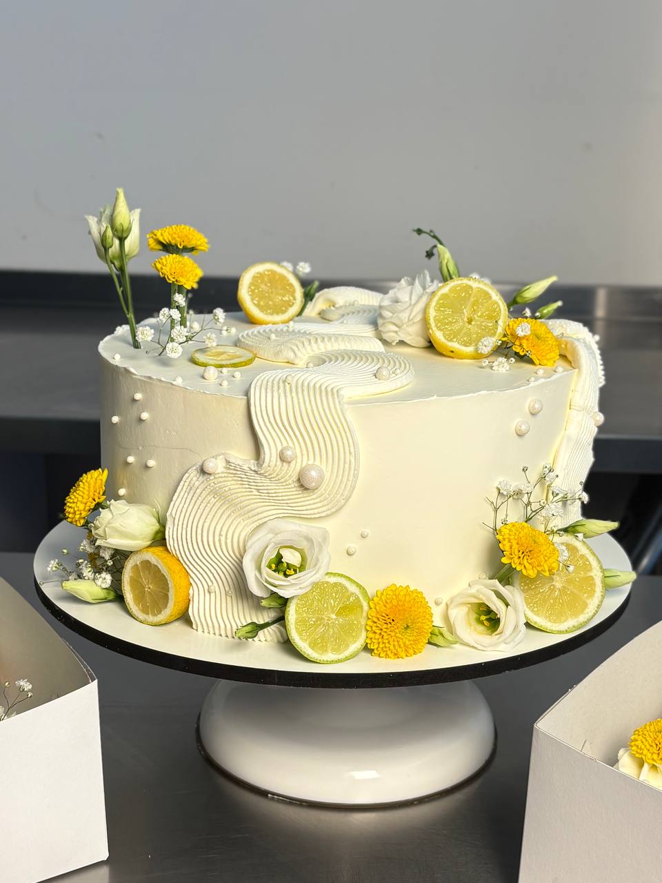 Lemon celebration cake with fresh citrus and flowers